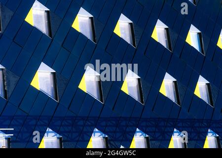 Abstract minimal style architecture background. Modern building facade detail. Geometric dark navy color exterior with windows. Modern building facade Stock Photo
