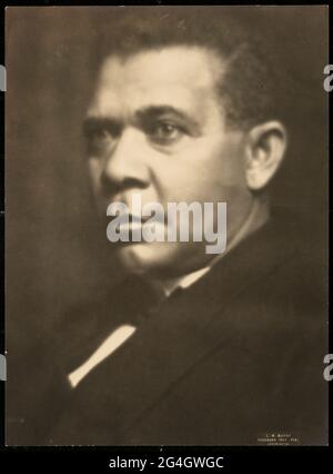 A black-and-white print of a bust-length portrait of Booker T. Washington, seated left. Born into slavery in Virginia, Booker Taliaferro Washington (1856-1915) was an African-American educator, author, orator, and adviser to several presidents of the United States. Stock Photo