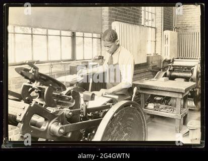 A gelatin silver print of a student working a printing press at the Manual Training and Industrial School for Colored Youth in Bordentown, New Jersey. The Bordentown boarding school for African-American students was founded in 1886. It was known as the "Tuskegee of the North" for its adoption of many of the educational practices first developed at the Tuskegee Institute in Alabama. Stock Photo