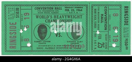 Green narrow ticket for the World Heavyweight Championship between African-American boxers Sonny Liston and Cassius Clay (Muhammad Ali). Muhammad Ali, born Cassius Marcellus Clay Jr. (1942-2016) was an African-American professional boxer, activist, entertainer, poet, and philanthropist. Ali famously refused to be drafted into the military, citing his religious beliefs and ethical opposition to the Vietnam War. Sonny Liston  (1930-1970) became World Heavyweight Champion in 1962, losing the title to Ali in Miami Beach, Florida. Ticket is divided two thirds of the way from the left by a large rec Stock Photo