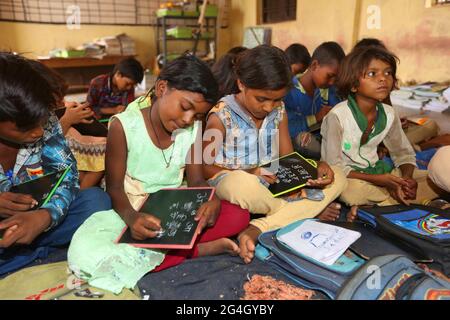 KOL TRIBE. Ashram School students busy in their studies in a classroom. Bhanpur Village of Huzur Tehsil in Rewa Dist, Madhya Pradesh, India Stock Photo