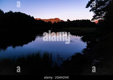 Beautiful sunrise or sunset on an alpine lake in the Pyrenees, Catalonia, Spain. Concept of vacations, summer, relaxation and disconnection in nature. Stock Photo