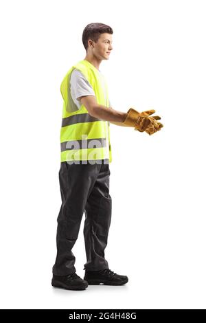 Full length profile shot of a young waste collector in a uniform and gloves gesturing with hands isolated on white background Stock Photo