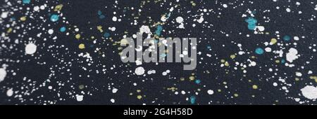Dark canvas with white-yellow blue spots closeup Stock Photo