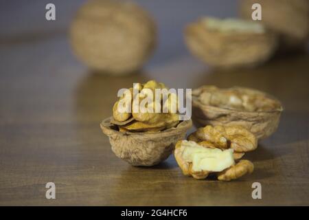 Walnuts kernels on dark wooden table. Stock Photo