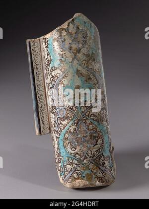 . Pilaster from quartz frying goods from a prayer décor decorated with flower drinks and floral elements and inscription (corentry) in brown luster, turquoise and blue on surface of white glaze. Stock Photo