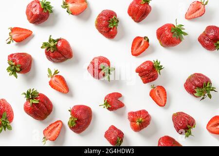 Pattern of ugly organic strawberry on white background. View from above. Concept organic products. Stock Photo