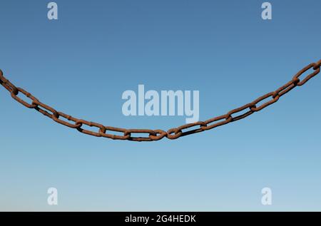 Old rusty chain on a background of blue sky Stock Photo