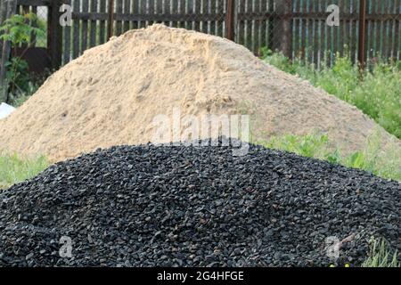 A pile of rubble for making concrete. A pile of sand for making concrete in the background. Selective focus. Stock Photo