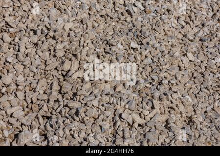 Dirty dry white limestone ballast flat full frame background. Stock Photo