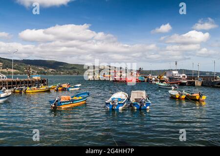 ANCUD, CHILE - MARCH 20, 2015: View of boats in a port of Ancud, Chiloe island, Chile. Stock Photo