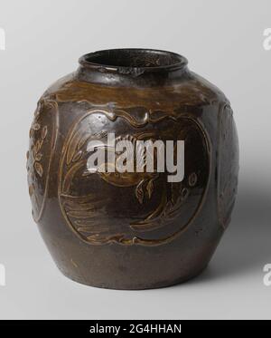 . Egg-shaped pot of stoneware, partly covered with a white sludge and an olive brown glaze. On the wall a decoration embossed of four scalloped cartouches with a blooming plant or a flying bird. On the shoulder a decorative bond under the glaze in white sludge. The bottom is unglazed. Some chips in the edge; A crack in the edge and wall. Old label on the bottom with 'W081'. Stock Photo