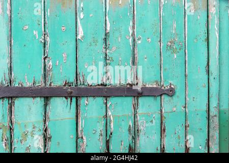 abstract rustic green painted barn door on a farm in northumberland Stock Photo