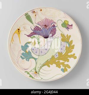 . Pottery wall plate, painted in green, yellow, turquoise, purple, wine red, blue, pink and red with large flowers and leaves and scaly fields. Two suspension holes in the foot ring. Stock Photo