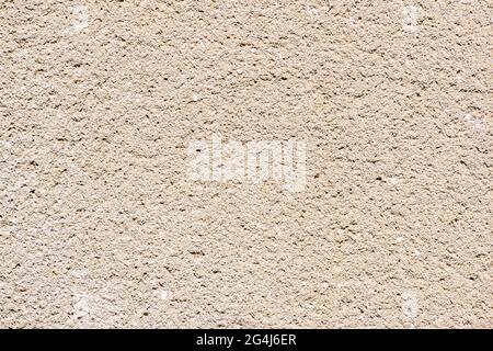 The structure of the coarse-grained stucco is almost white on the outer plastered wall. rough white grained plaster texture closeup Stock Photo