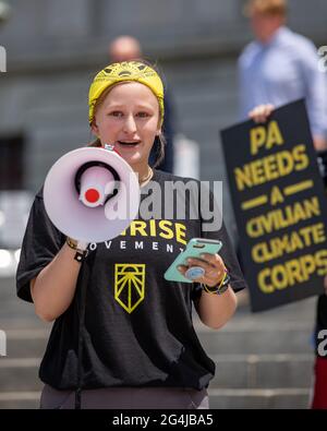 Harrisburg, United States. 21st June, 2021. A Sunrise Movement climate activist speaks during a rally at the Pennsylvania State Capitol. After the rally the activists set off on a week-long trek to Washington, DC where they will deliver demands to the Biden Administration and Congress. Credit: SOPA Images Limited/Alamy Live News Stock Photo