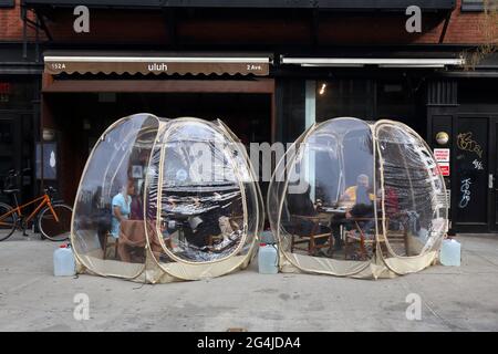 Outdoor dining bubbles at a restaurant in New York, NY. The individual dining enclosures were setup to adhere to NYC dining restrictions during covid Stock Photo