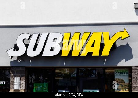 A brightly-lit Subway restaurant signage. Stock Photo