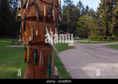 HEDESUNDA, SWEDEN ON MAY 19, 2021. View of a wooden artwork. Fishing lures, wobblers on wooden background. Editorial use. Stock Photo