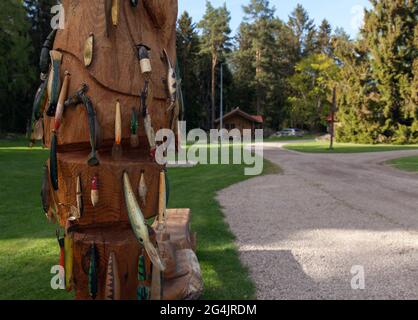HEDESUNDA, SWEDEN ON MAY 19, 2021. View of a wooden artwork. Fishing lures, wobblers on wooden background. Editorial use. Stock Photo