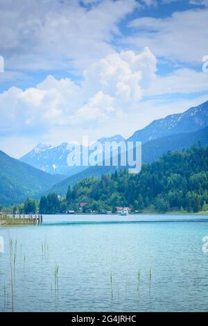 View of Lake Weissensee and mountains in the distance in cloudy weather, vertical format Stock Photo