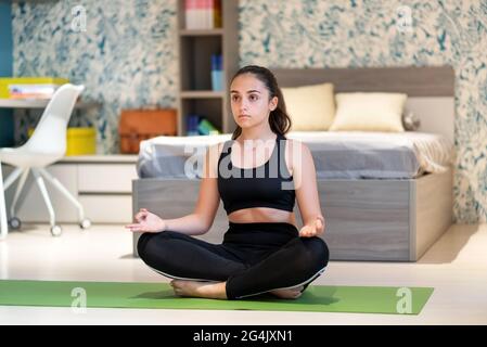teenage girl in Lotus pose yoga position Stock Photo - Alamy