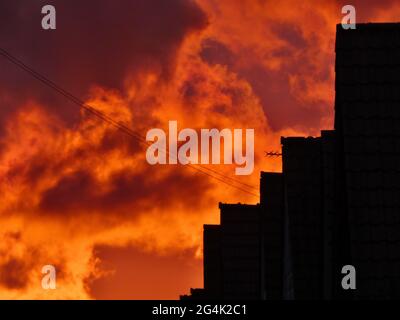 Dramatic sky during sunset with stormy clouds and house shadows Stock Photo