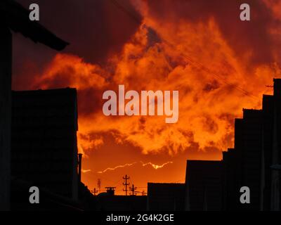 Dramatic sky during sunset with stormy clouds and house shadows Stock Photo