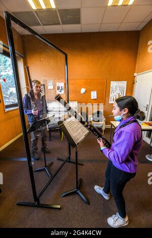 Music lesson at the Rouen music academy during the COVID 19 pandemic, on February 12, 2021. Young girl, teenager, learning how to play the bassoon Stock Photo