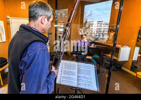 Music lesson at the Rouen music academy during the COVID 19 pandemic, on February 12, 2021. Young girl, teenager, learning how to play the bassoon Stock Photo