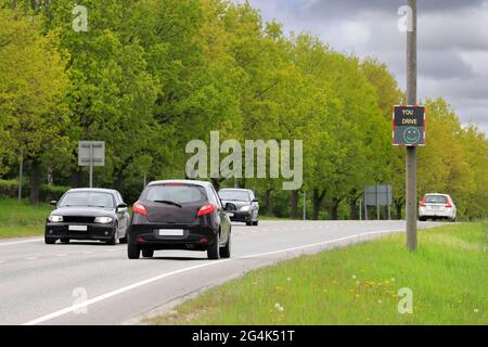 Speed monitoring device showing a happy green smiley face to a driver who is going at the legal speed. Stock Photo