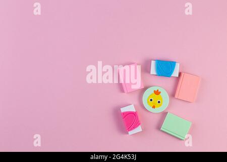 Colorful rubber erasers on a pink background. Multicolored school supplies. Concept Hello September or Back to school, education. school stationery on Stock Photo