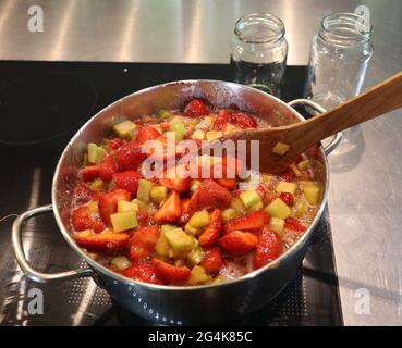 cooking pot with rhubarb and strawberries for home made jam Stock Photo