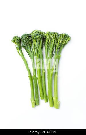 Raw broccolini heap isolated on white background Stock Photo