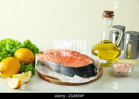 Concept of cooking salmon on white textured background Stock Photo