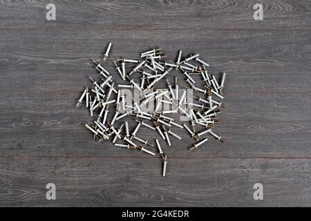 view from above of the bunch of metal steel screws or dowels with plastic caps isolated on table Stock Photo