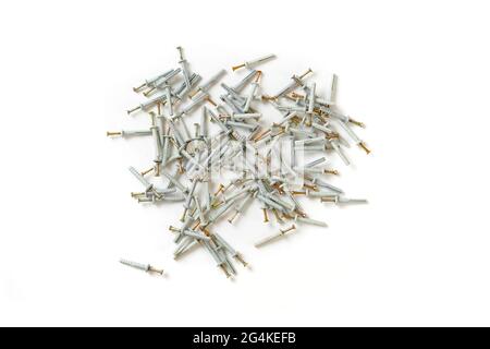 view from above of the bunch of metal steel screws or dowels with plastic caps isolated on table Stock Photo