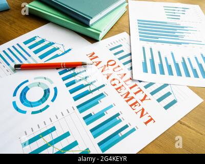 Quality management report with data and pen. Stock Photo