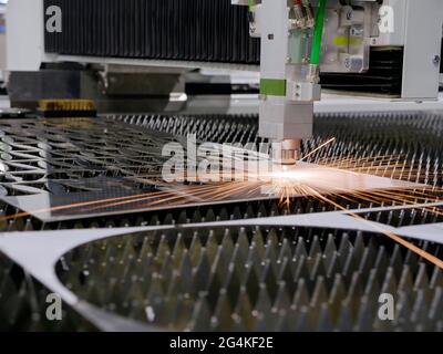 Industrial laser cutting of metal. Automatic machine in the factory. Stock Photo