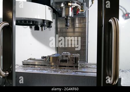 Automatic milling machine after the production of the part in the factory. Stock Photo