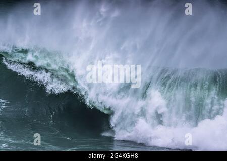 A wild wave breaking on the Cribbar Reef off Towan Head in Newquay in Cornwall. Stock Photo