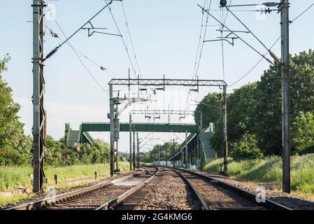 Electrified train tracks / railway lines, transport infrastructure. Stock Photo