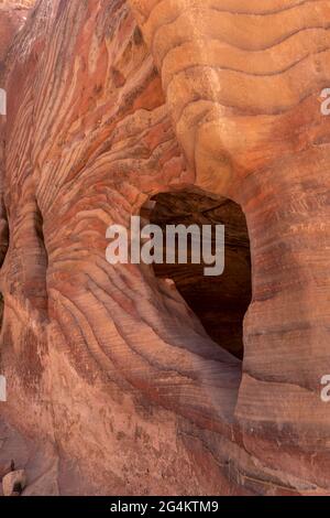 The multi-colored exposed sandstone rock and mineral layers inside the ancient tombs of Petra, Jordan. Stock Photo