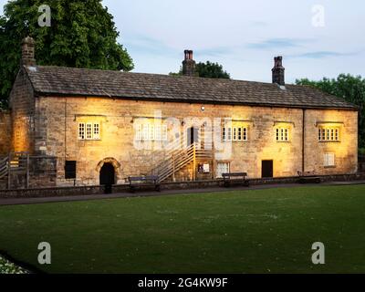 The Couthouse Museum floodlit at dusk in the Castle Grounds at Knaresborough North Yorkshire England Stock Photo