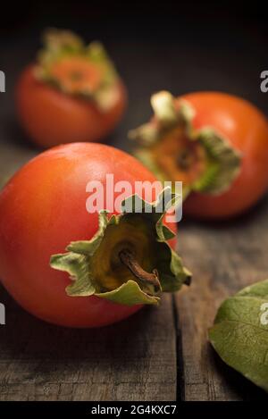 Kaki on wood, Sicily, Italy, Europe Stock Photo