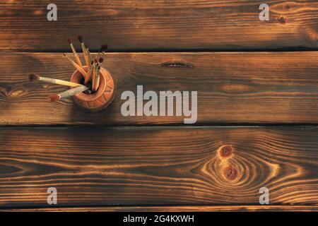 Paint brushes on wooden background Stock Photo