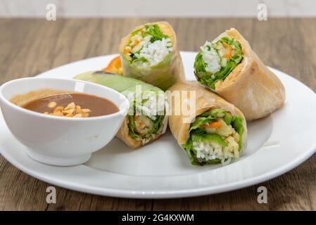 Hearty plate of tofu spring rolls cut in halves for a complete meal. Stock Photo