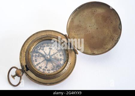 Old brass marine compass on a white background Stock Photo