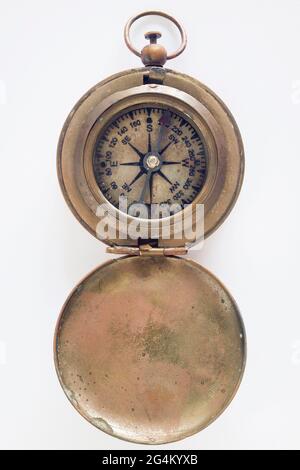 Old brass marine compass on a white background Stock Photo