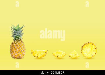 Collection of group pineapples and sliced isolated on yellow pastel colors background. Stock Photo